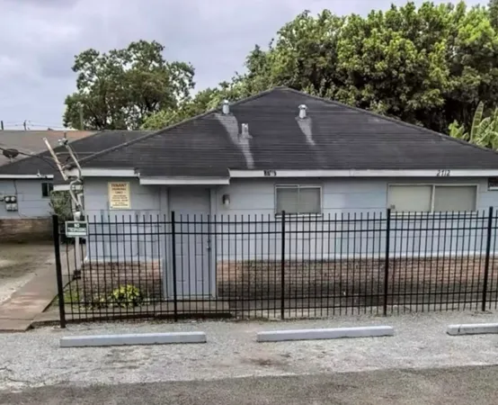 a view of a house with a fence