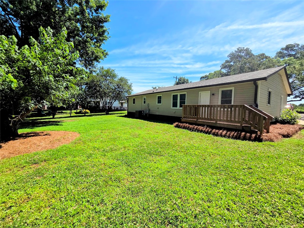 509 Elrod Road Piedmont, SC 29673 - Photo 26 of 28 A sprawling lawn surrounds this home featuring a charming deck, perfect for outdoor relaxation.