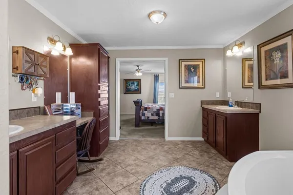 a large kitchen with granite countertop a sink and cabinets
