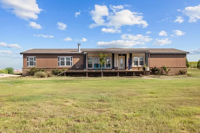 a front view of house with yard and seating