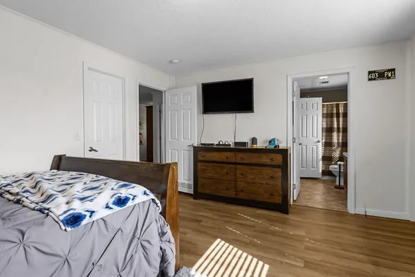 a bedroom with a bed and a baby crib