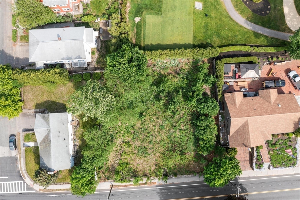 301 Common Street Watertown, MA 02472 - Photo 4 of 6 an aerial view of a house with a yard and garden