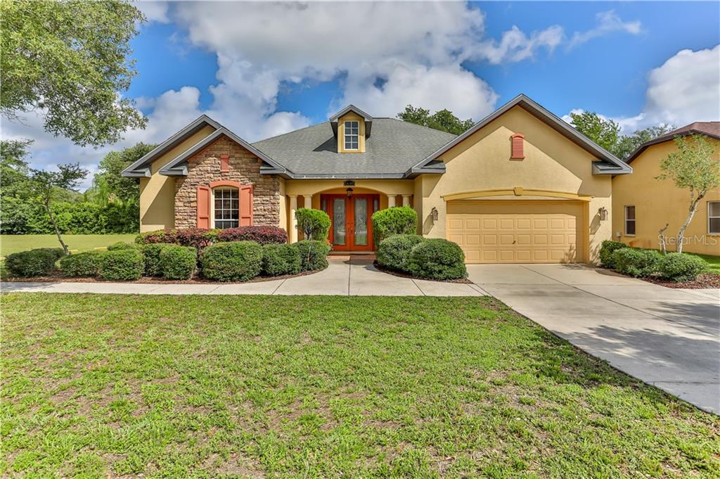 a front view of a house with a yard and garage