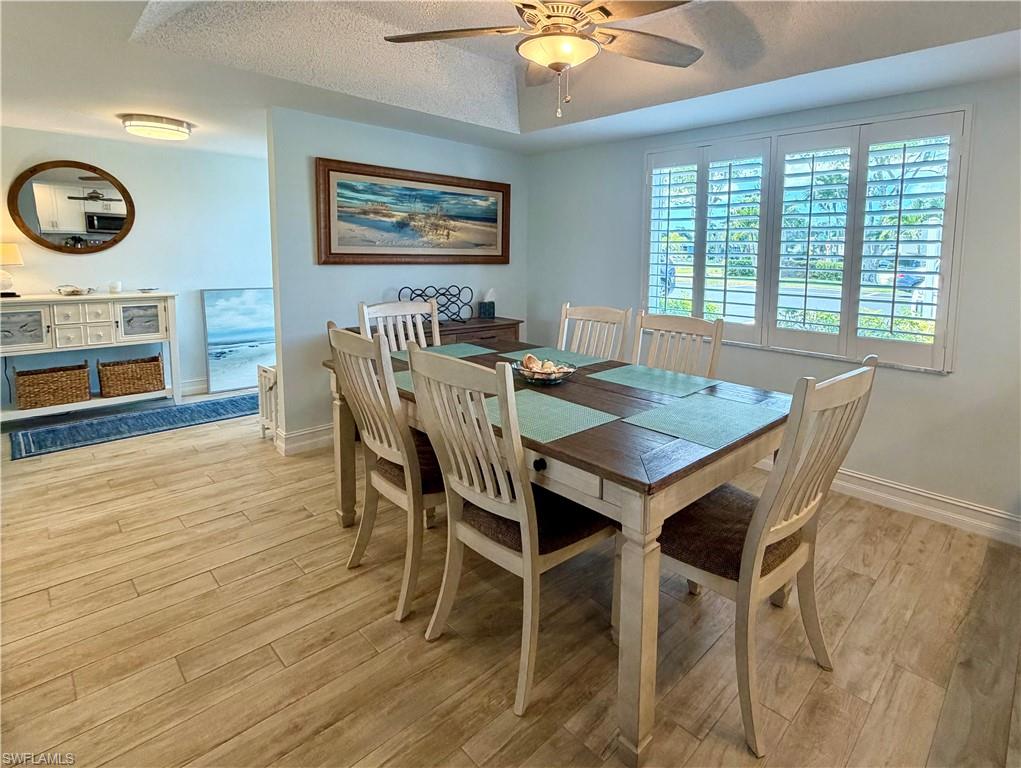 105 Penny Lane, Unit 5 Naples, FL 34112 - Photo 2 of 15 a view of a dining room with furniture window and wooden floor