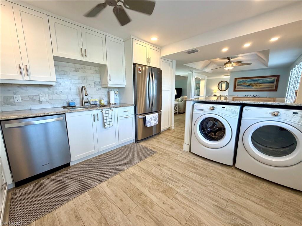 105 Penny Lane, Unit 5 Naples, FL 34112 - Photo 5 of 15 a kitchen with stainless steel appliances granite countertop a sink a stove a refrigerator and cabinets
