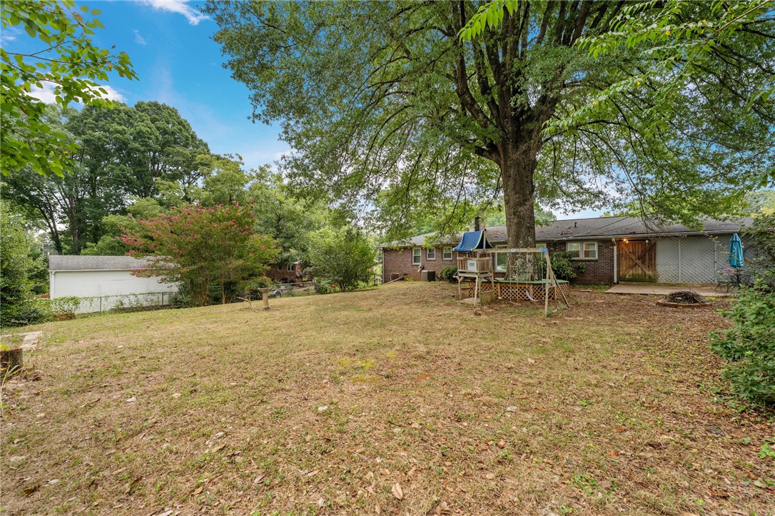 2807 Bellview Road Anderson, SC 29621 - Photo 26 of 31 Mature trees shade a spacious lawn leading to the brick exterior of this home.
