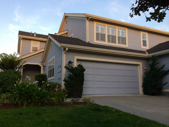 a front view of a house with a garden