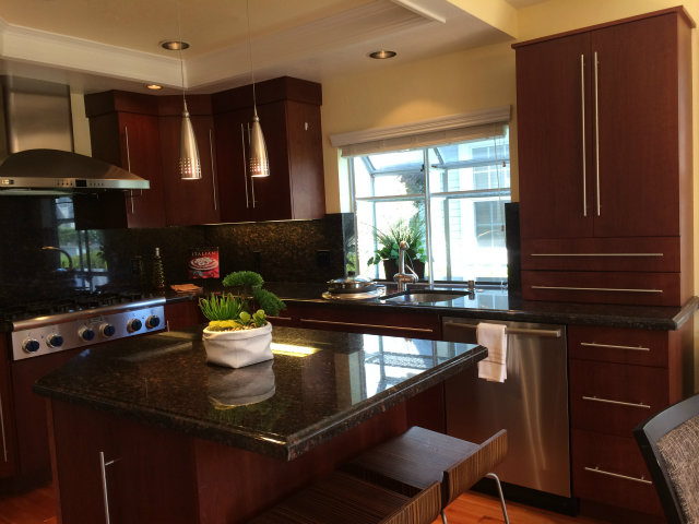 9 Muirfield Road Half Moon Bay, CA 94019 - Photo 4 of 16 a kitchen with a sink a stove and wooden cabinets