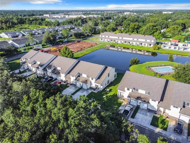 an aerial view of a house with a swimming pool yard and outdoor seating