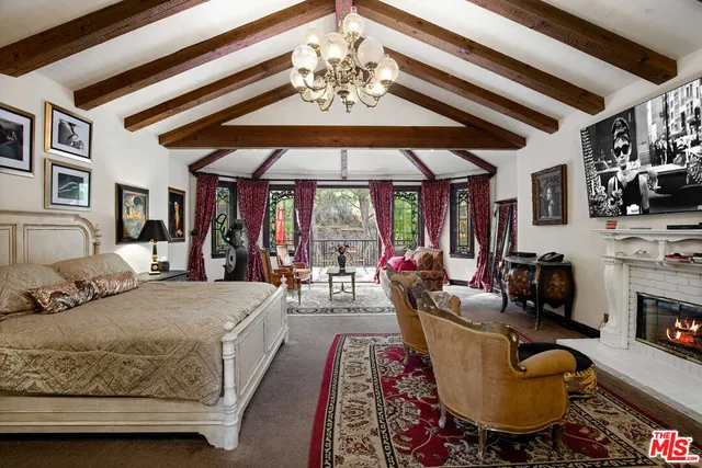 a living room with furniture a fireplace and a chandelier
