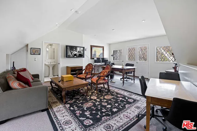 a front view of a house with a yard and fountain in middle