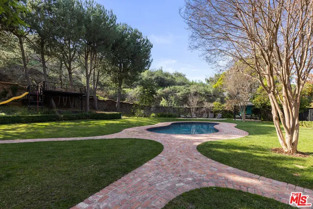 a view of a swimming pool with a yard