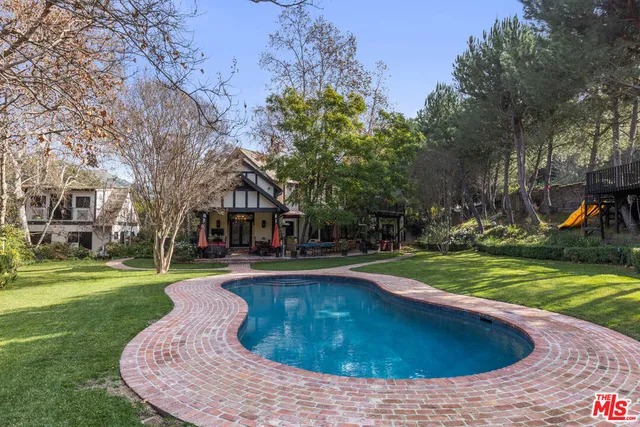 a backyard of a house with outdoor seating