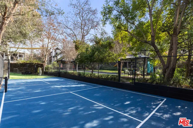 a view of a swimming pool with a patio and a yard
