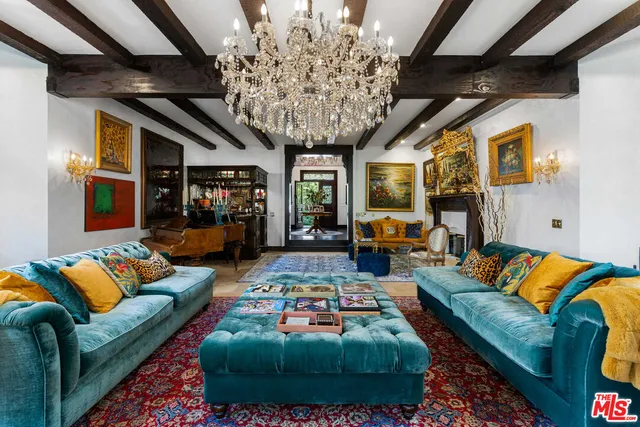 a living room with furniture and a chandelier