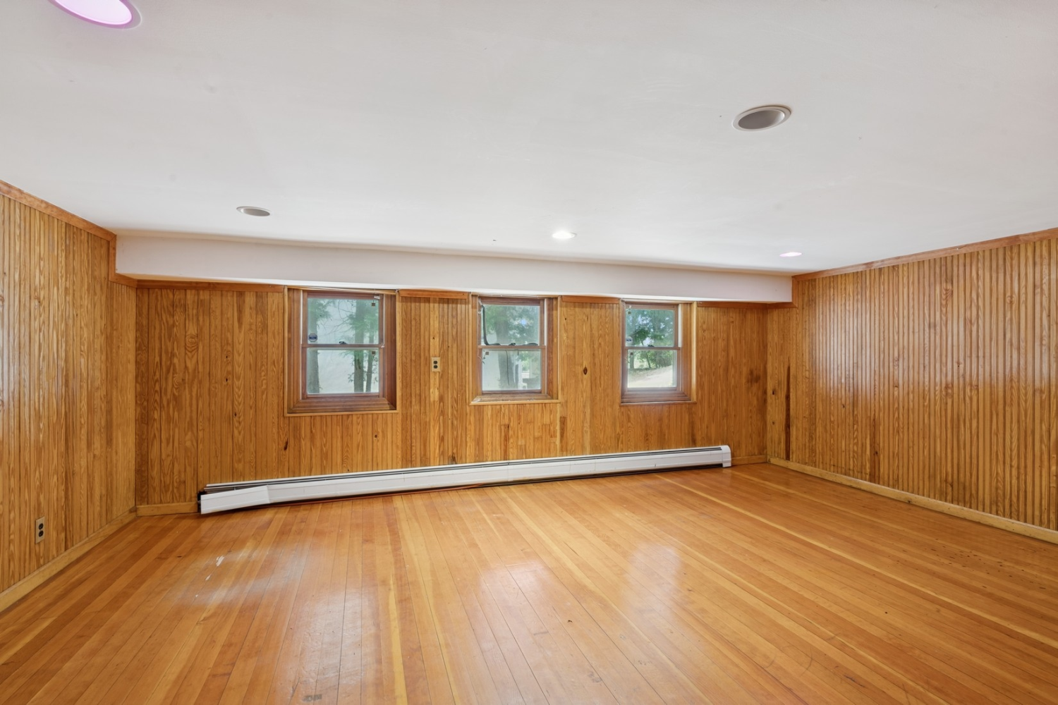 1197 Todt Hill Road Staten Island, NY 10304 - Photo 11 of 17 an empty room with wooden floor and windows