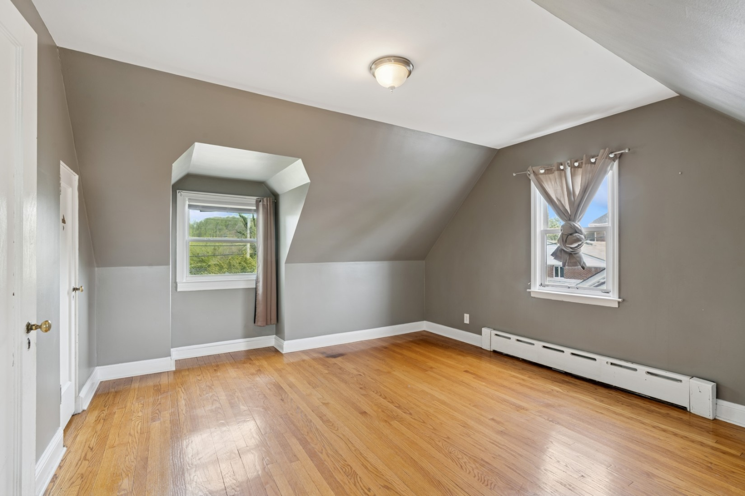 1197 Todt Hill Road Staten Island, NY 10304 - Photo 13 of 17 wooden floor in an empty room with a window