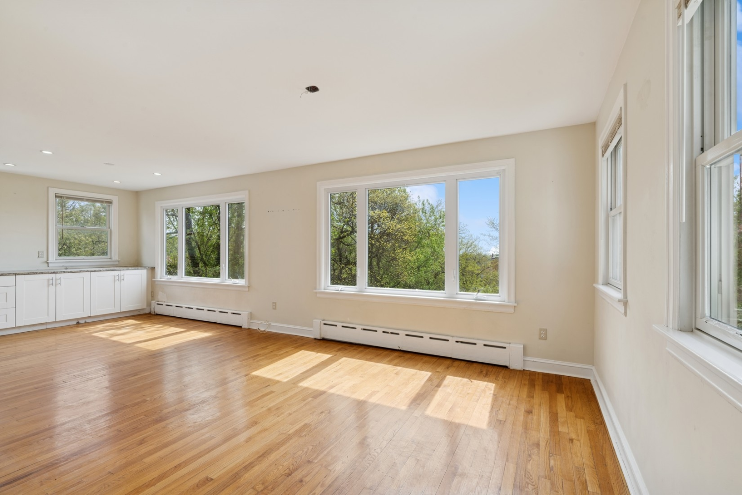1197 Todt Hill Road Staten Island, NY 10304 - Photo 14 of 17 a view of an empty room with wooden floor and a window