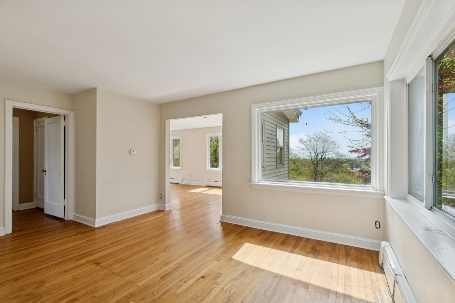 1197 Todt Hill Road Staten Island, NY 10304 - Photo 15 of 17 a view of an empty room with wooden floor and a window