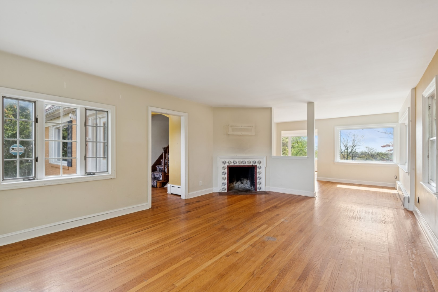 1197 Todt Hill Road Staten Island, NY 10304 - Photo 16 of 17 a view of empty room with wooden floor and fireplace