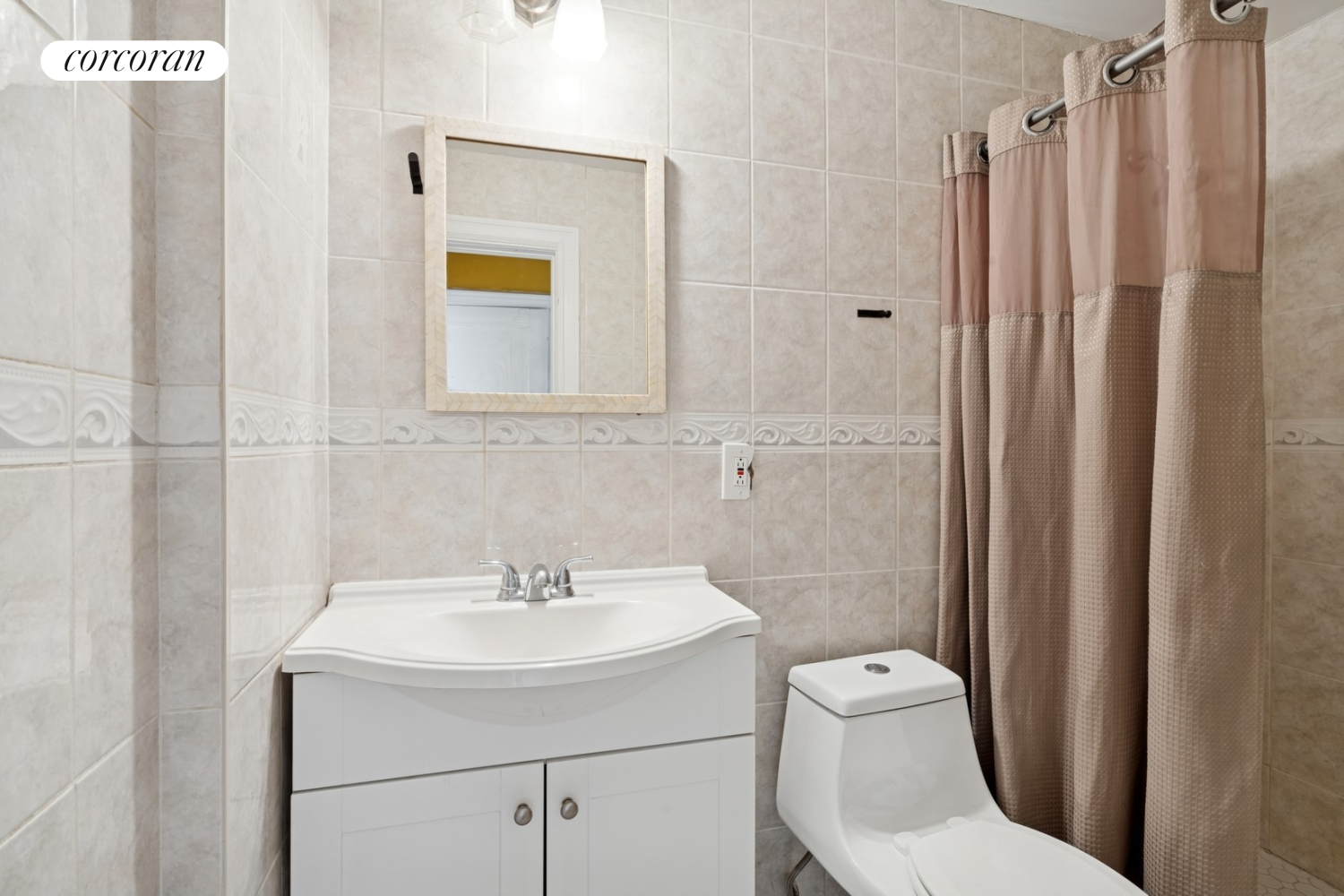 1197 Todt Hill Road Staten Island, NY 10304 - Photo 7 of 17 a bathroom with a sink a toilet and shower curtain