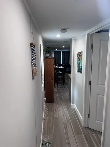 a view of a hallway with wooden floor