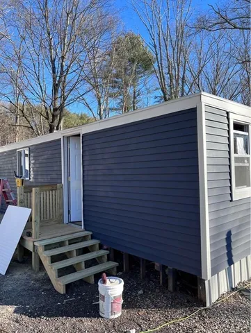 a front view of a house with a garden