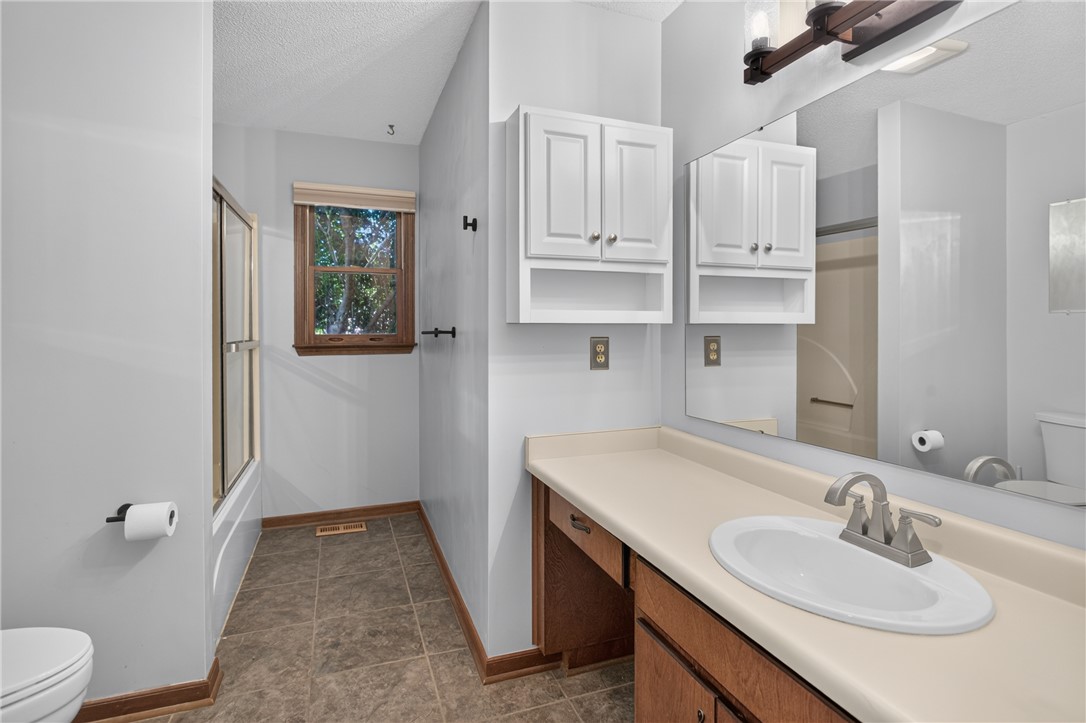 103 Dorsey Lane Walhalla, SC 29691 - Photo 21 of 42 A well-lit bathroom features a functional vanity and a combined shower-tub area.