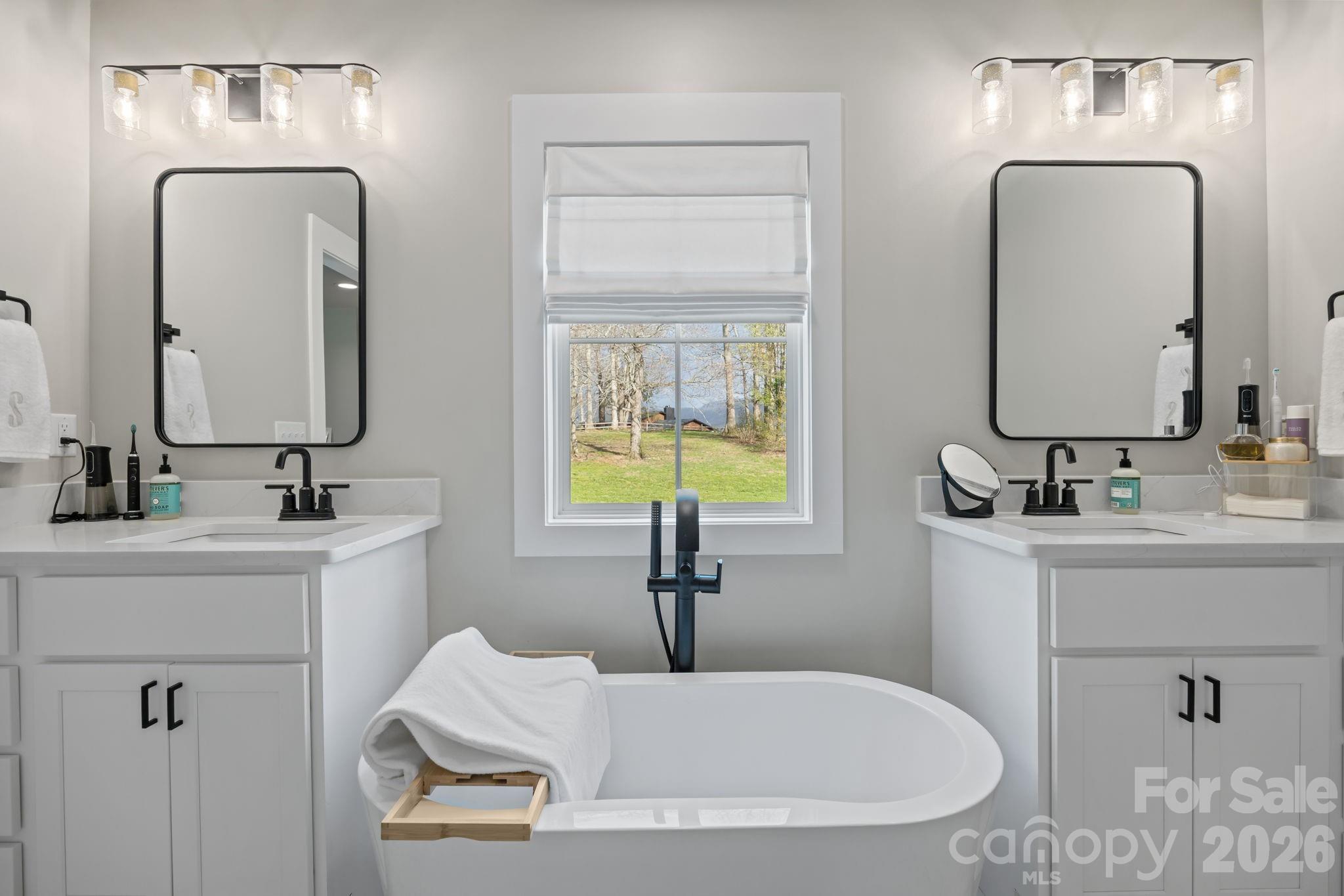 234 Gravely Branch Road Fletcher, NC 28732 - Photo 23 of 46 a bathroom with double vanity sinks and a mirror