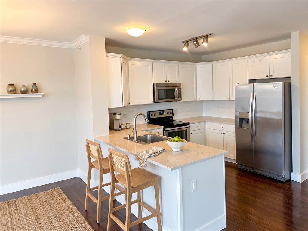 a kitchen with stainless steel appliances a refrigerator stove microwave and sink