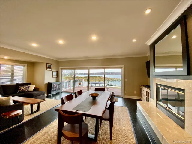 a living room with furniture a fireplace and a large window