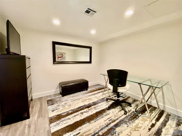 a bedroom with a bed and a chair
