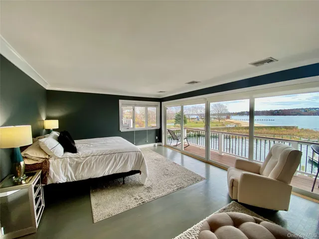 a bedroom with furniture and a large window