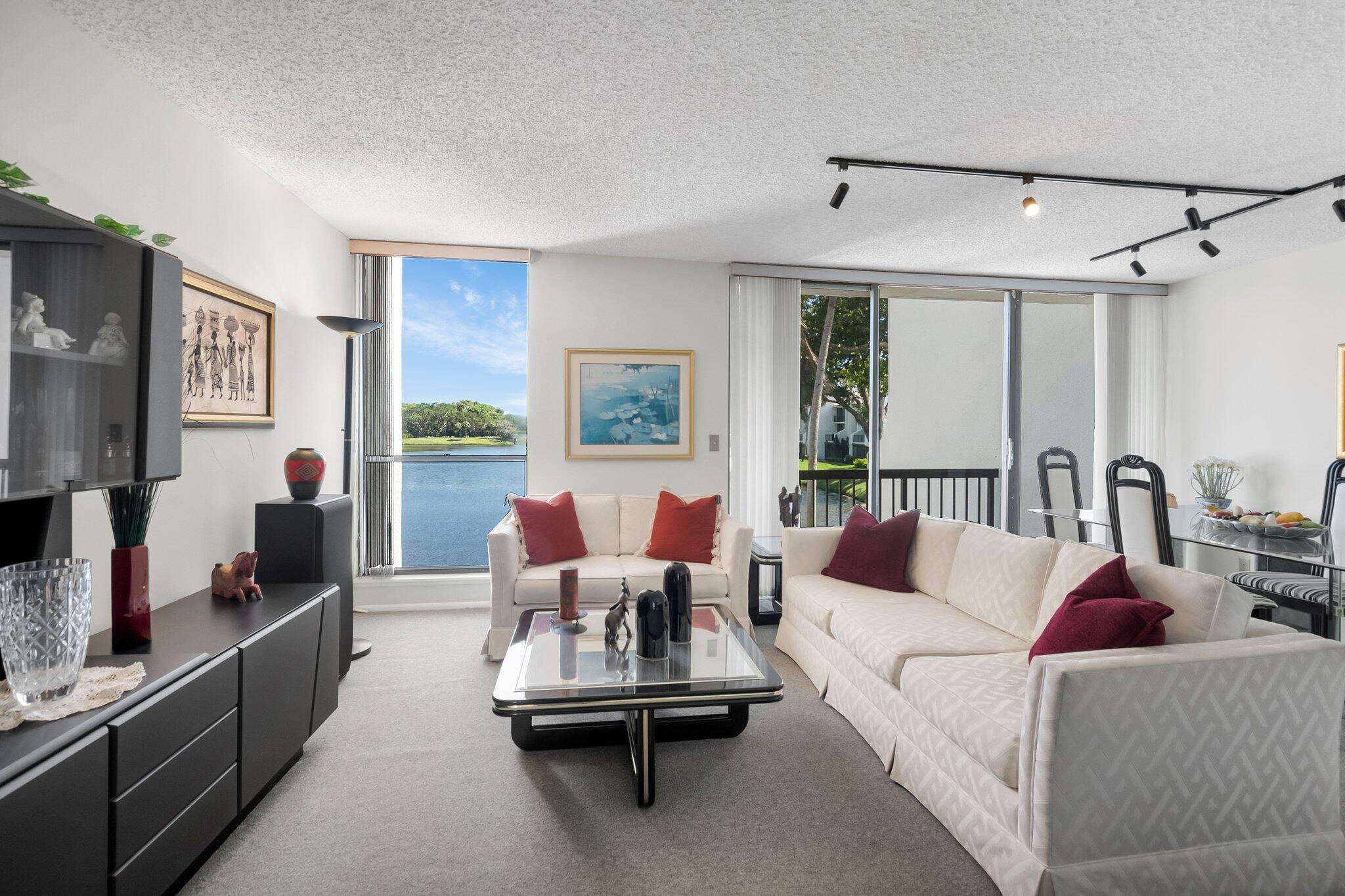 a living room with furniture large window and flat screen tv