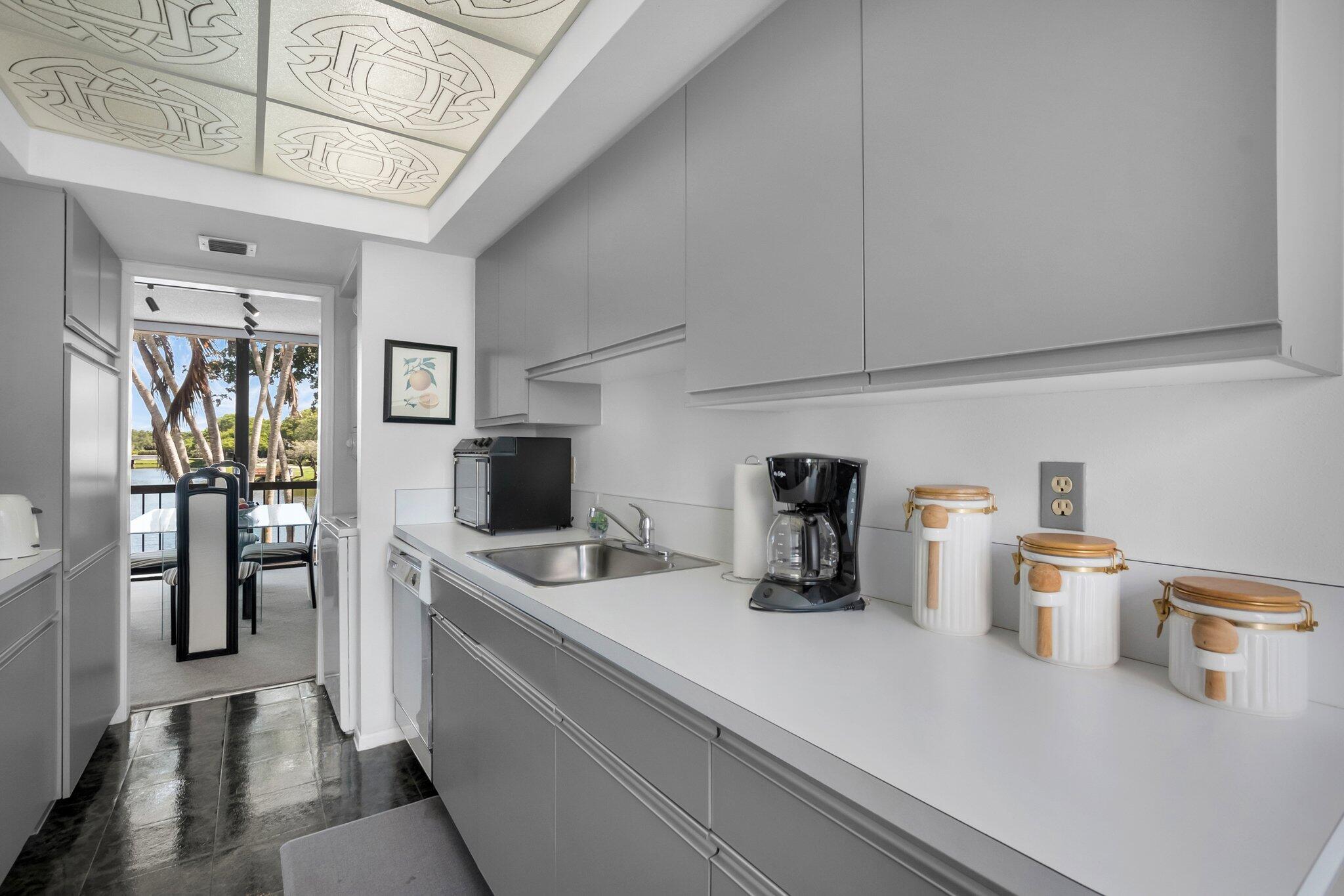 805 Bridgewood Place Boca Raton, FL 33434 - Photo 12 of 60 a kitchen with a refrigerator and a sink