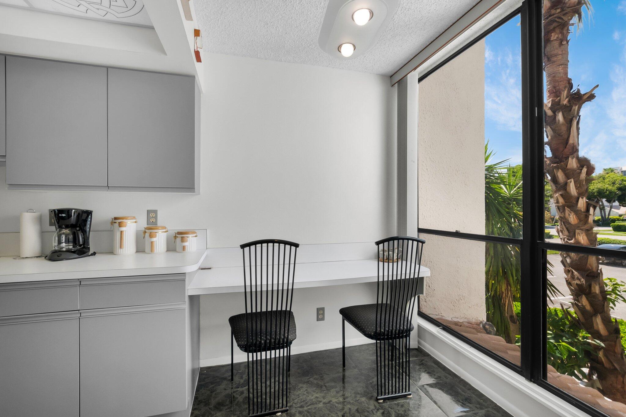 805 Bridgewood Place Boca Raton, FL 33434 - Photo 13 of 60 a kitchen with a table chairs and a window