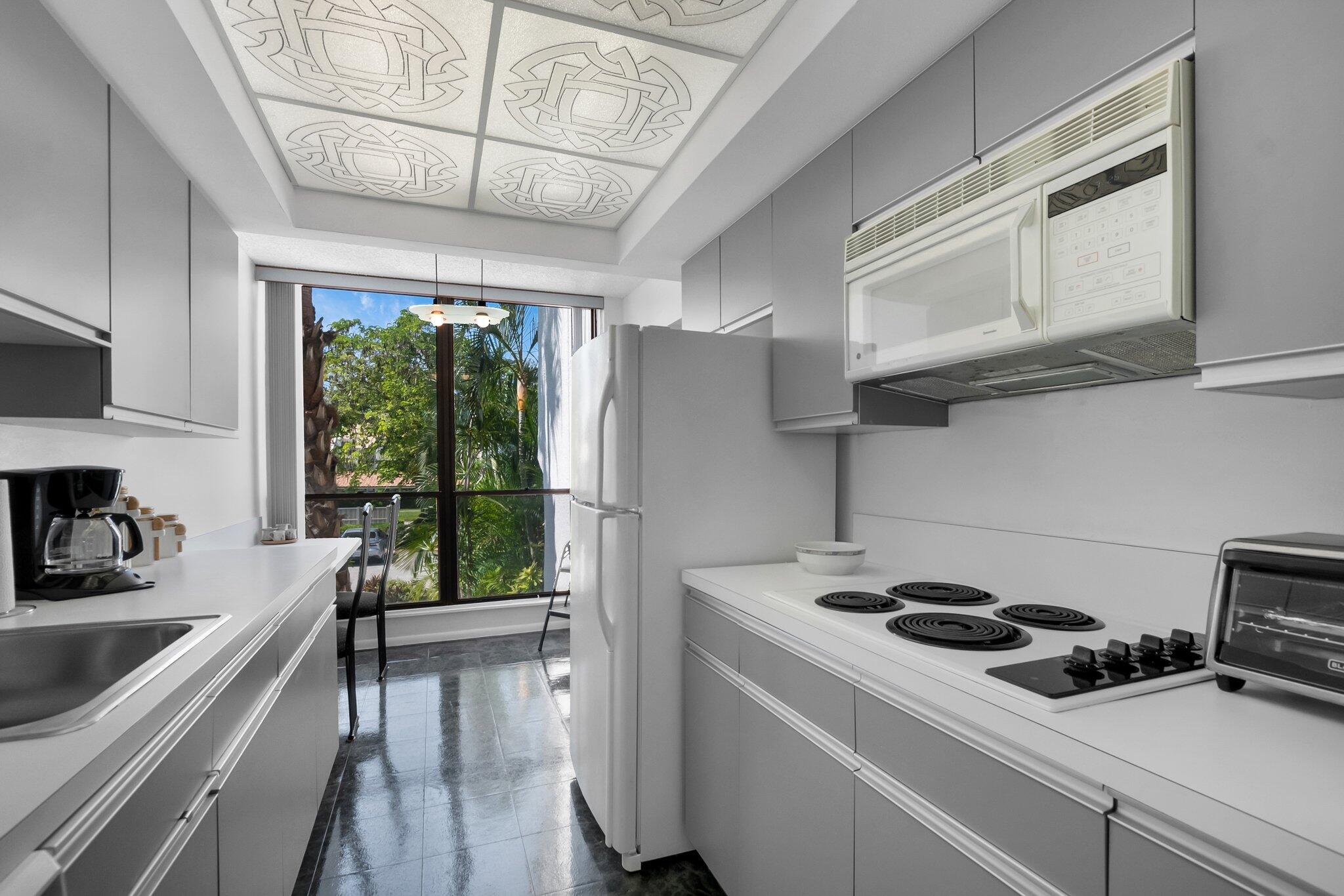 805 Bridgewood Place Boca Raton, FL 33434 - Photo 15 of 60 a kitchen with a stove a refrigerator and a sink