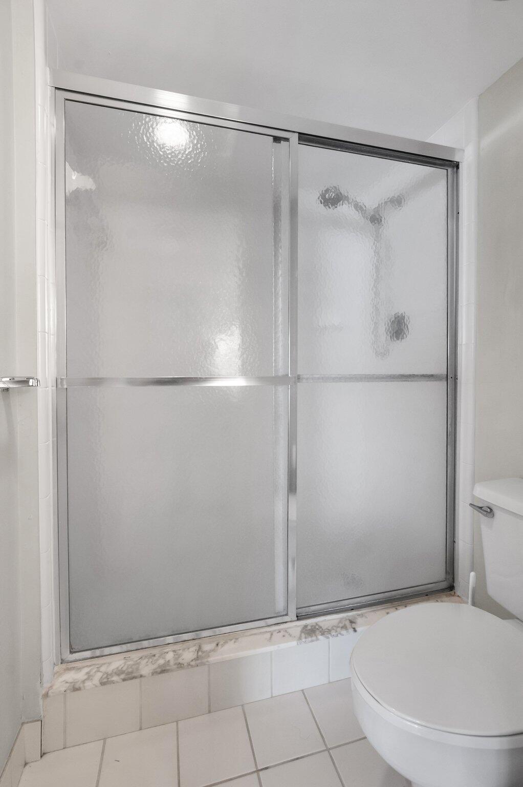 805 Bridgewood Place Boca Raton, FL 33434 - Photo 19 of 60 a bathroom with a glass shower door