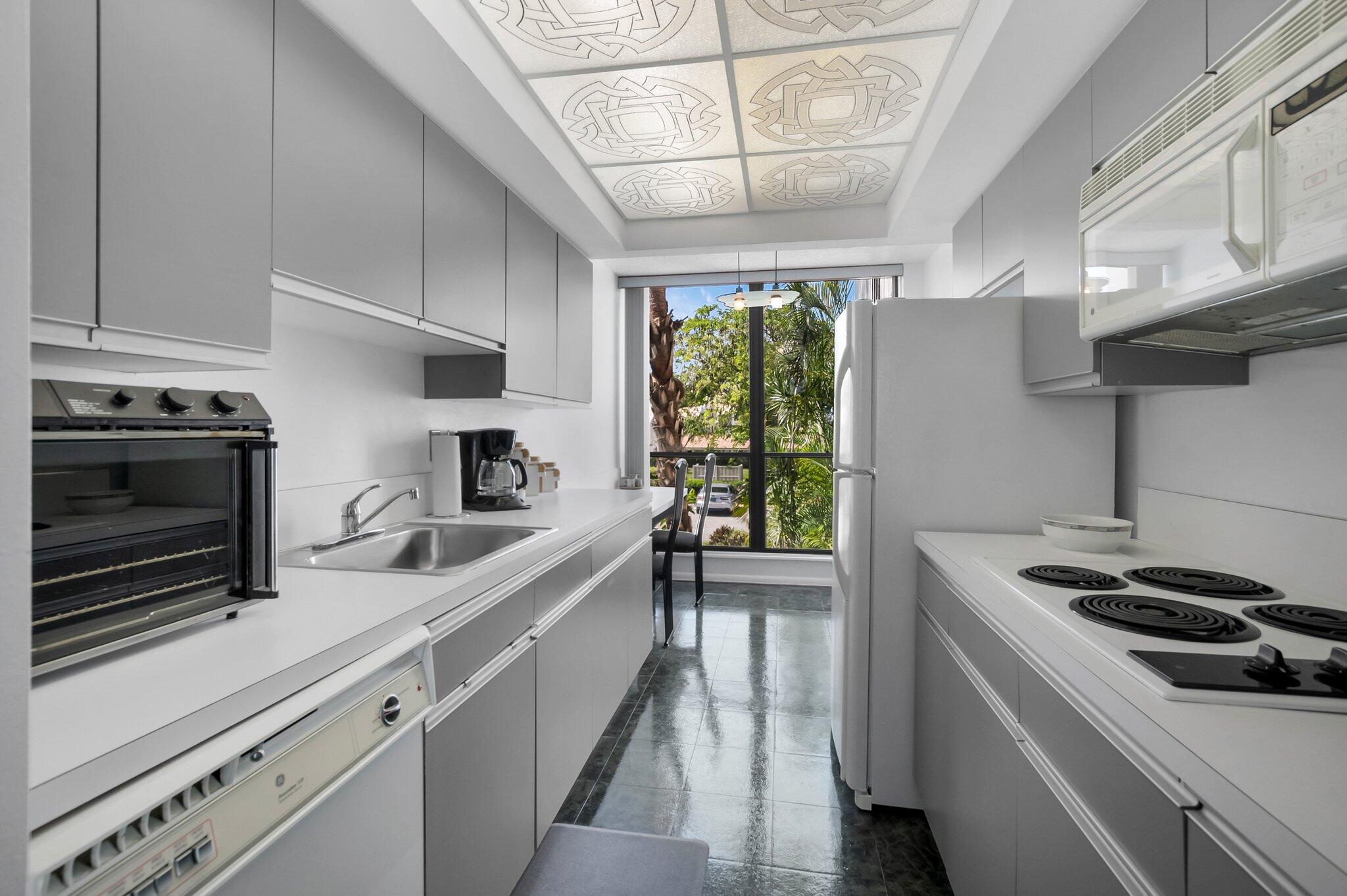 805 Bridgewood Place Boca Raton, FL 33434 - Photo 3 of 60 a kitchen that has a sink and a stove