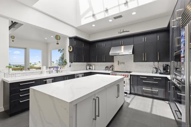 a kitchen with a sink stove and cabinets