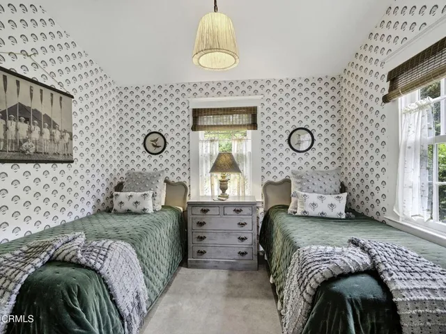 a view of a hallway and a livingroom with furniture