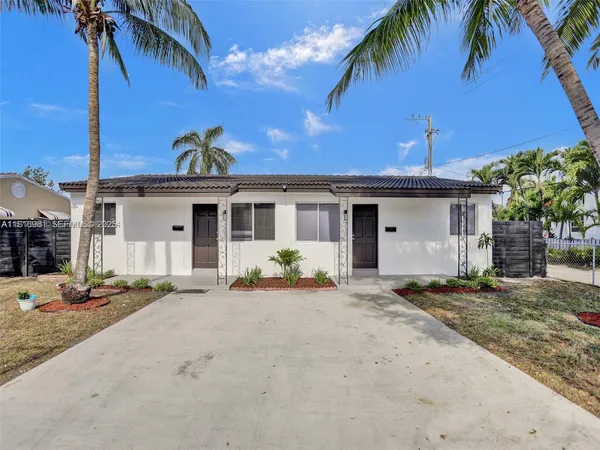 a front view of a house with a yard and outdoor seating