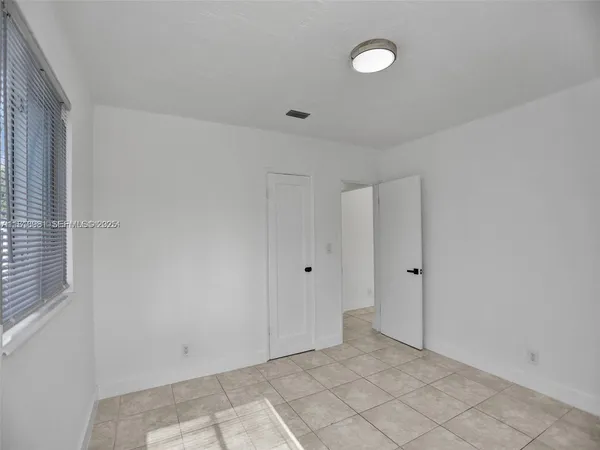 an empty room with a empty space and window