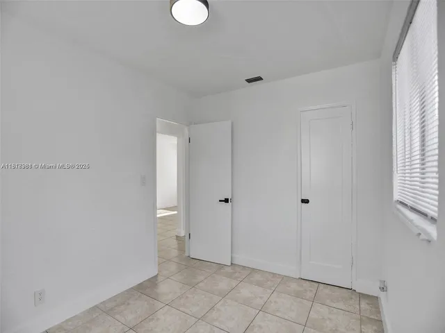 a view of an empty room and window