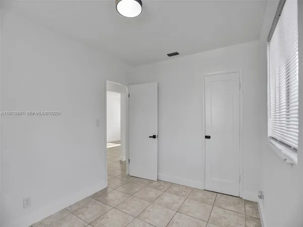 a view of a kitchen with a sink and a refrigerator
