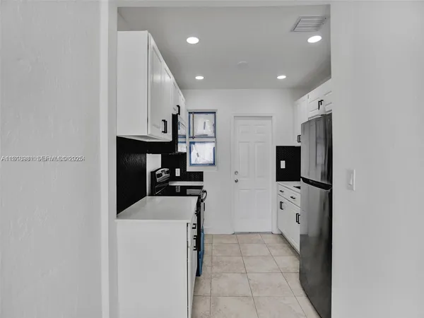 a kitchen with a stove microwave and refrigerator