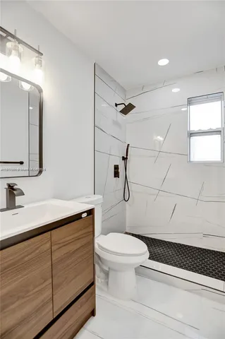 a kitchen with granite countertop a sink stainless steel appliances and cabinets
