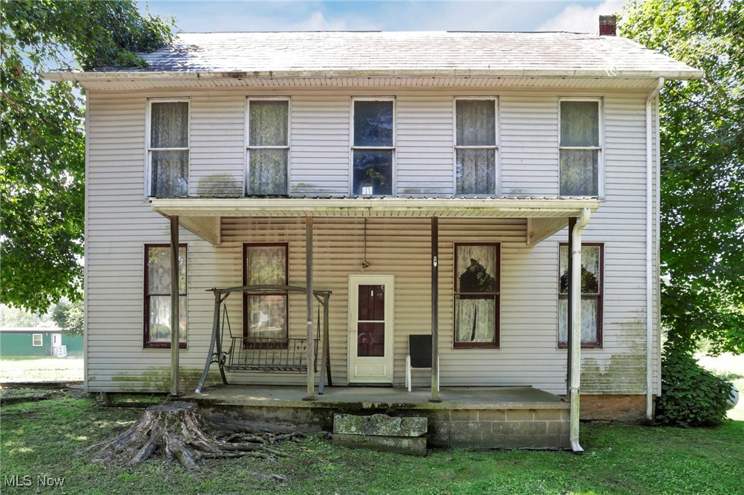 21372 Bridgewater Road Quaker City, OH 43773 - Photo 1 of 39 View of front of home featuring a porch and a chimney