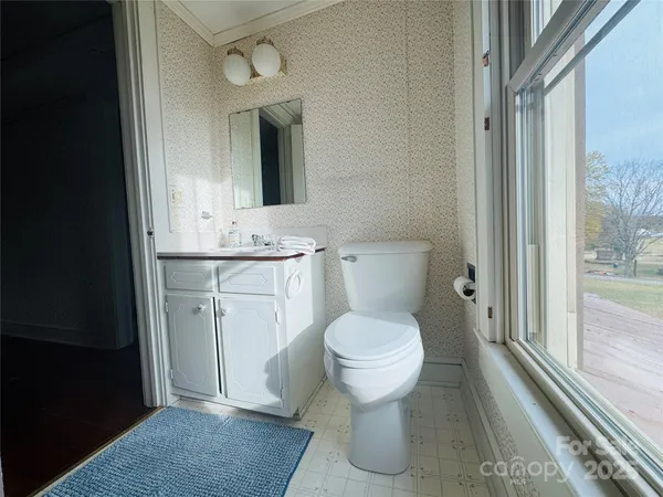 a bathroom with a toilet sink and mirror
