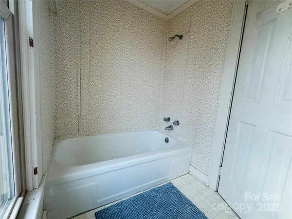 a bath tub sitting next to a white sink and vanity